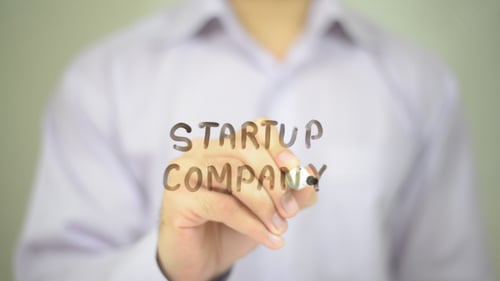 Startup Company Written on Clear Surface by Hand