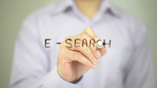 Hand Writes E-Search with Marker on Glass