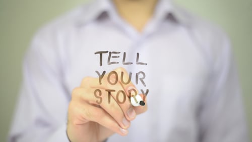 Writing Tell Your Story on Glass with Marker