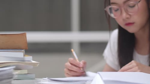Diligent Young Adult Studying at Desk Indoors