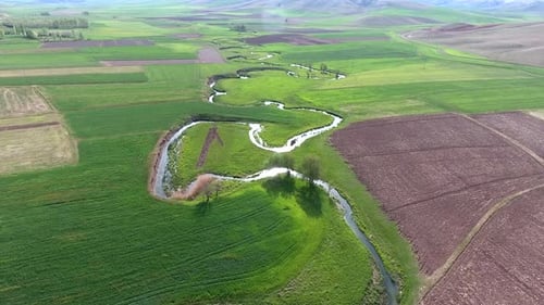 Meander Stream Between The Fields in Wide Valley