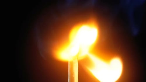 Match Ignites With Flame Against Black Background