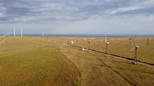 Turbinas eólicas en el campo a lo lejos en el horizonte del mar, una vista desde la altura del