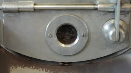 Working Process Of Mixing Fried Coffee Grains. Coffee Factory.