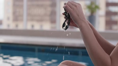 Female Swimmer Putting Goggles On