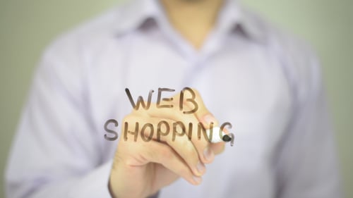 Adult Writes Web Shopping on Glass Surface