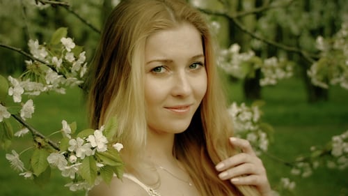 Happy Woman Portrait In The Blooming Spring Garden