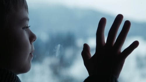 Boy Behind Window In Winter