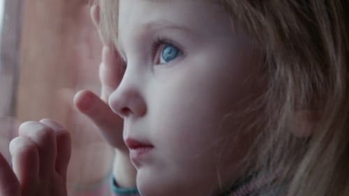 Little Cute Girl Behind Window In Winter