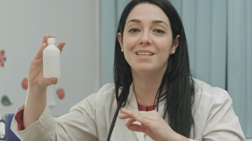 Smiling Female Doctor Presenting And Recommending Drugs