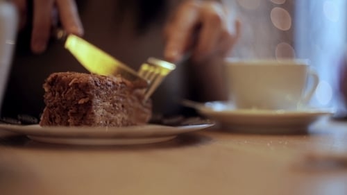 Girl Eating Cake And Drinking Coffee In Cafe