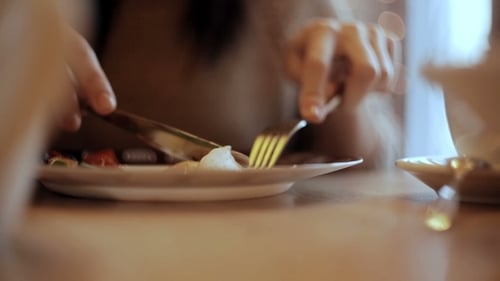 Woman Eats Vegetable And Meat In Cafe