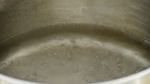 Water boils in stainless steel cooking pot