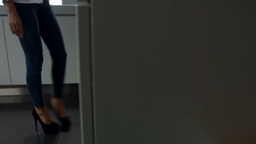 Woman Getting Glass Container Out of Kitchen Drawer