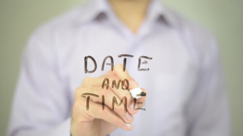 Hand Writes Date and Time on Clear Surface