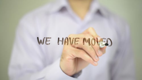 Writing 'We Have Moved' on Glass Surface