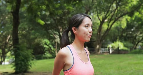 Sport woman stretching arm in park