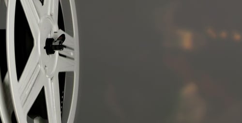 Film Reel Spinning on Grey Background