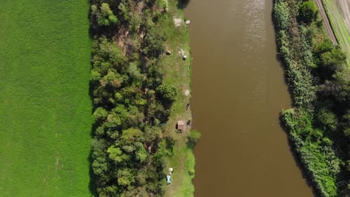 Aerial view of the trees, meadow and river.