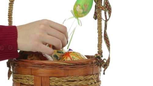 Placing Decorated Easter Eggs in Wicker Basket