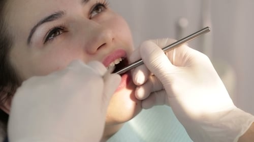 Woman Has Her Teeth Checked In a Dentist Office