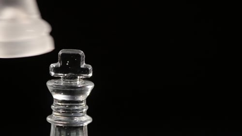 Chess King Piece Knocked Over Against Black Background