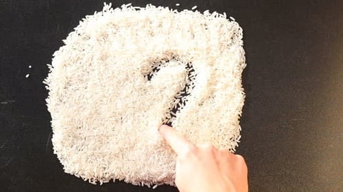 Drawing Heart Shape with Uncooked Rice Grains