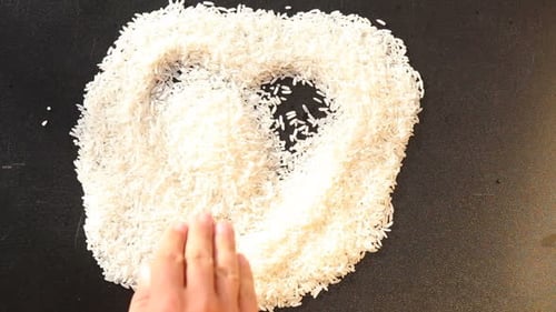 Flattening White Rice on a Black Surface