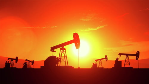 Industrial Oil Pumpjacks Pumping at Sunset Silhouette