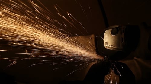 Power Tool Grinds Metal in Dark with Sparks