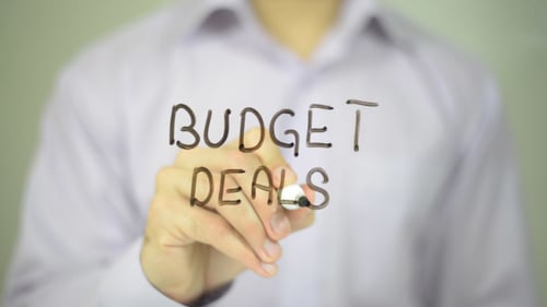 Writing Budget Deals on Clear Surface With Marker