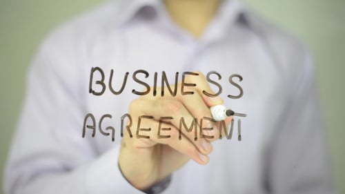 Writing Business Agreement on Glass