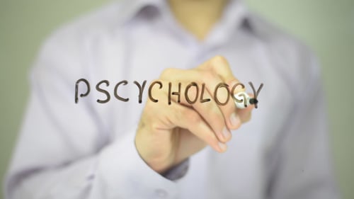 Man Writing Psychology on Clear Surface