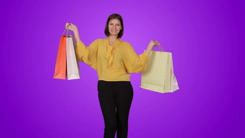 Woman Smiling and Holding Shopping Bags