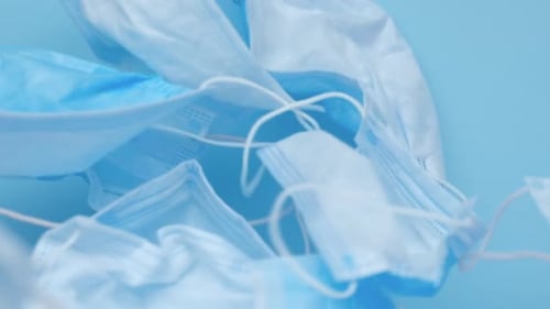 Many Medical Face Masks on Blue Background