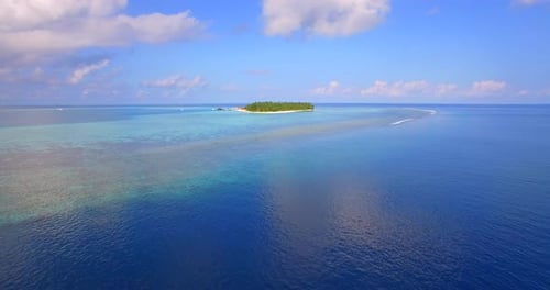Aerial drone view of a scenic tropical island in the Maldives.