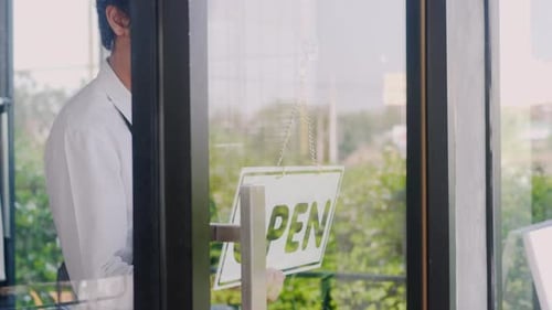 young man staff turning round sign to close on door