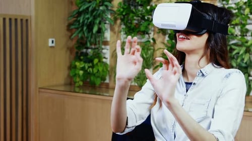 Woman Experiencing Immersive Virtual Reality in Modern Office