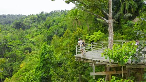 Aerial View Young Couple on the Observation Deck in the Form of a Boat in the Jungle in Bali