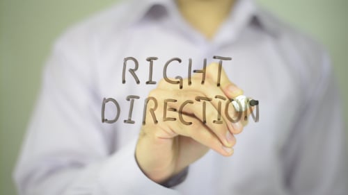 Hand Writes Right Direction on Clear Surface