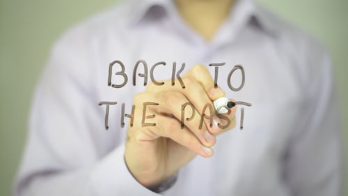 Hand Writes "Back to the Past" on Clear Surface