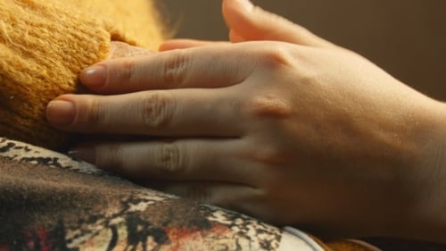 Young Adult Holding Senior's Hand with Love