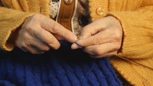 Wrinkled Hands Knitting Blue Wool Garment Close Up