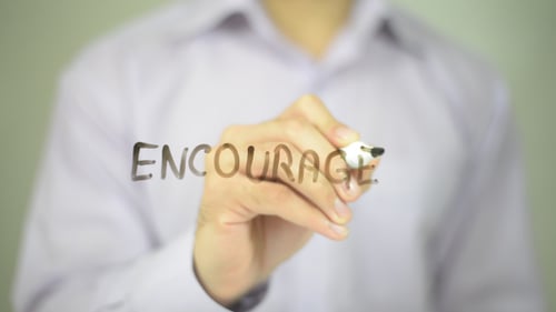 Man Writes Encourage with Marker
