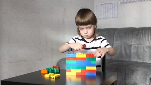 Child Building Colorful Toy Block Structure