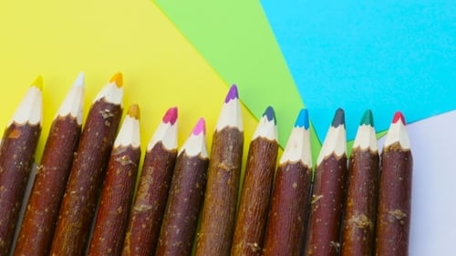 Colorful Pencils with Rustic Wood Grain on Paper