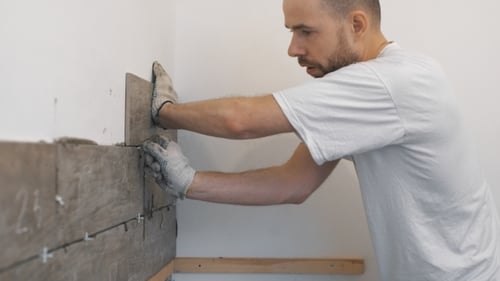 Man Installing Wood-Look Tiles on Wall