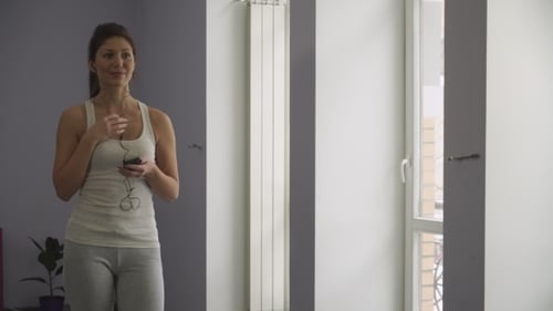 The Woman In The Gym Listening To Music On The Phone.