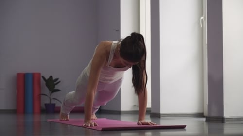 Woman Doing Yoga in Bright Indoor Setting