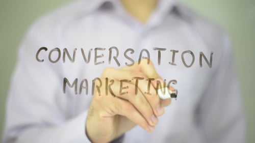 Hand Writes Conversation Marketing on Clear Surface